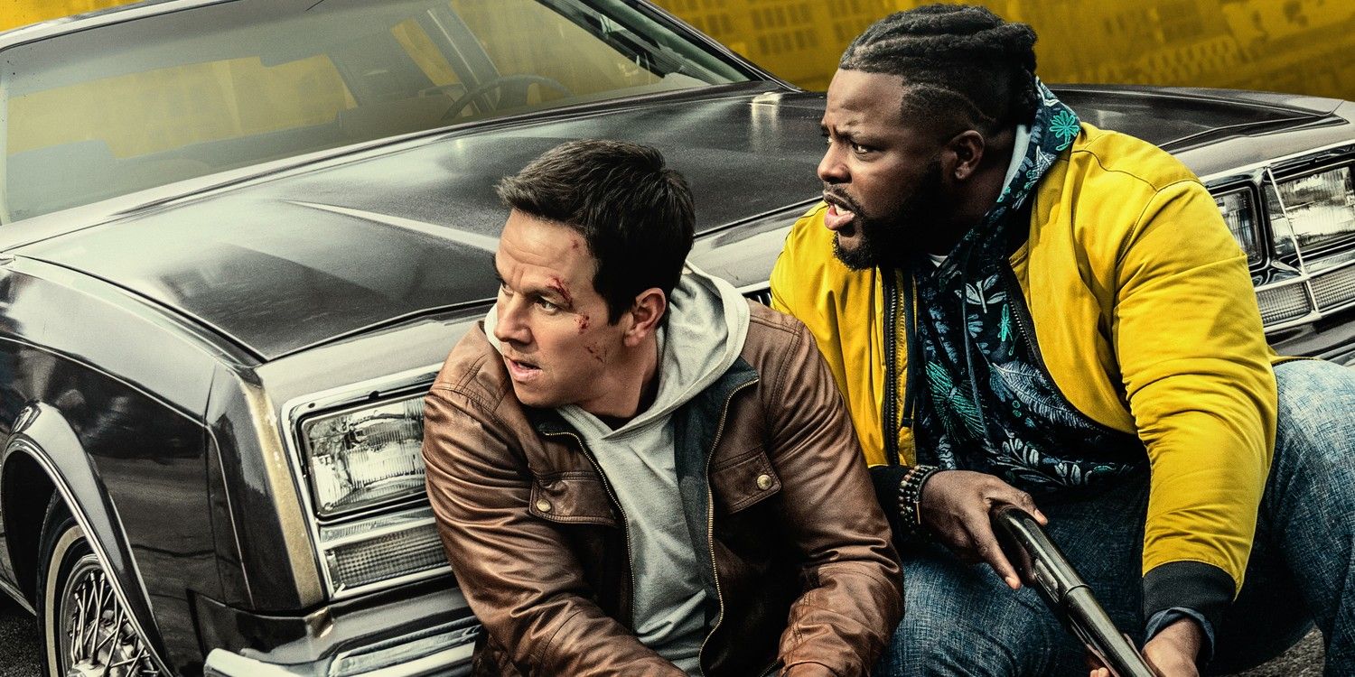 Mark Wahlberg and Winston Duke camping  in front of a car in Spenser Confidential