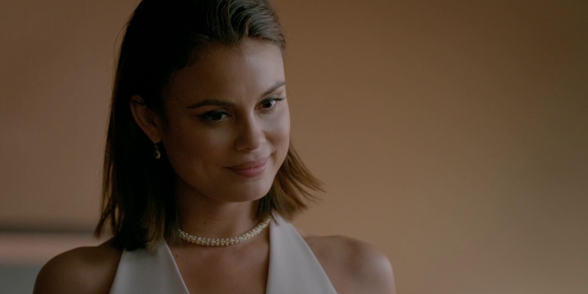 Sybil smiling and looking pleased in The Vampire Diaries.