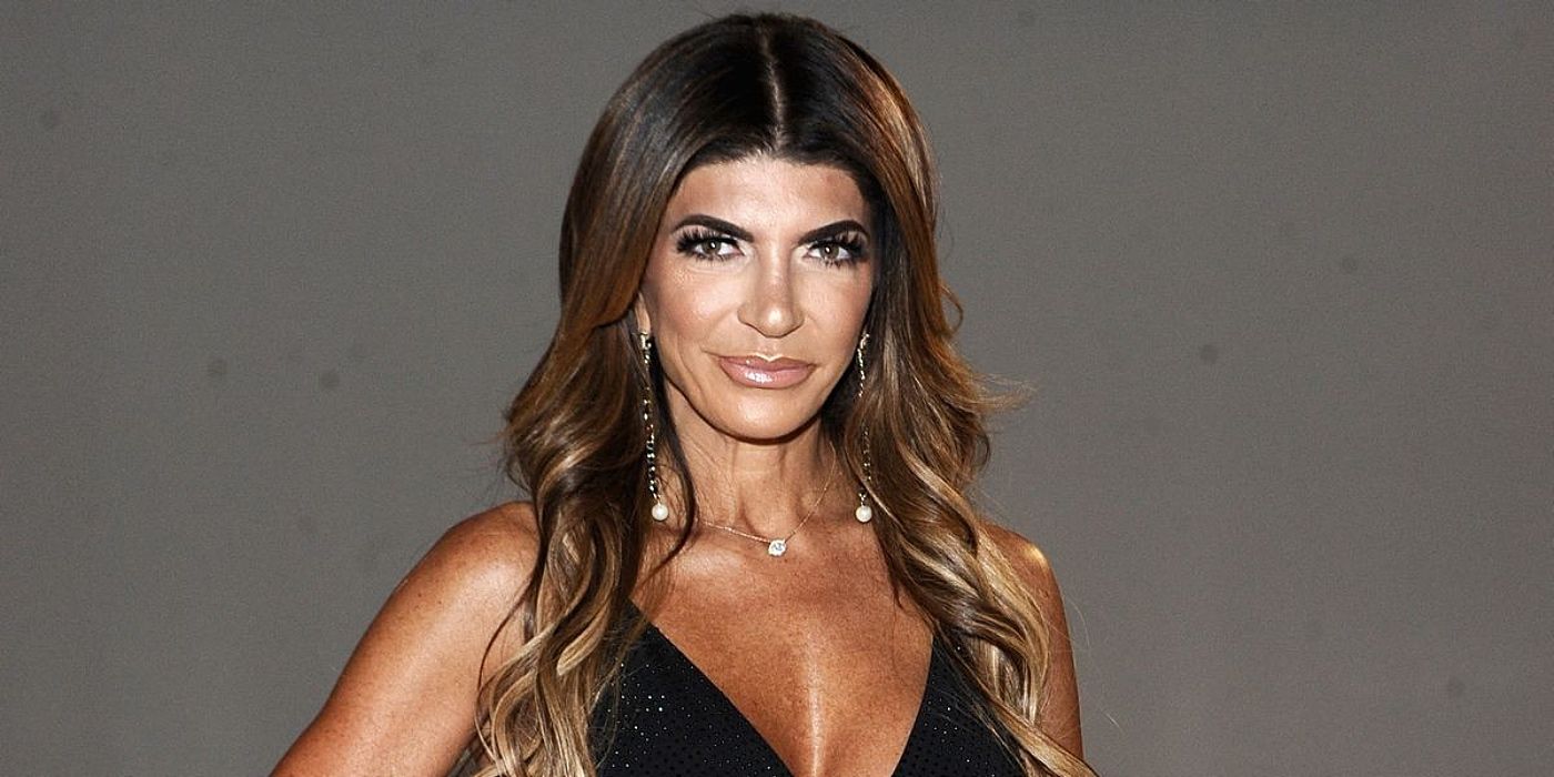 Teresa Giudice from The Real Housewives of New Jersey soft smiling in black dress.