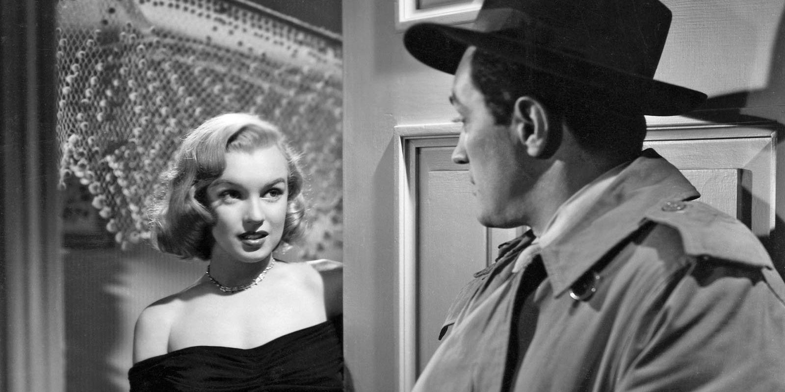 A man and woman talk through a doorway from The Asphalt Jungle