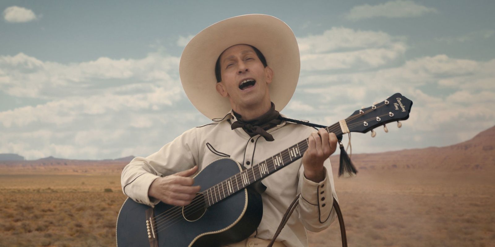 Tim Blake Nelson plays the guitar on horseback in The Ballad of Buster Scruggs