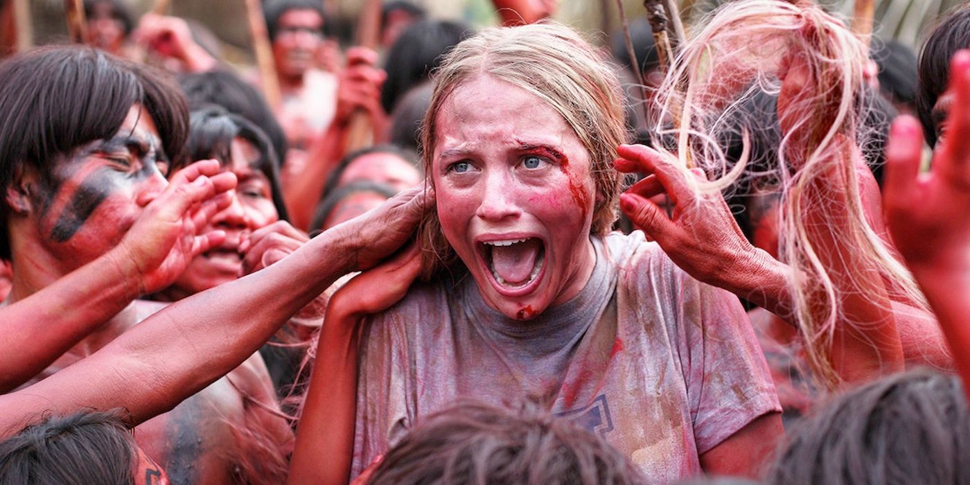 Crowd of locals covered in red in The Green Inferno.