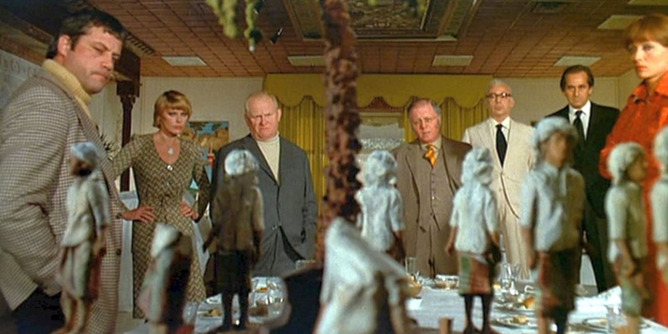 The guests eye the statues in Ten Little Indians