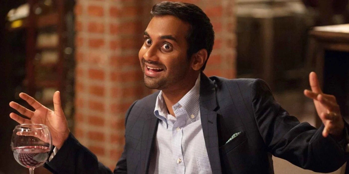 Tom Haverford smiling and raising his hands in Parks and Rec