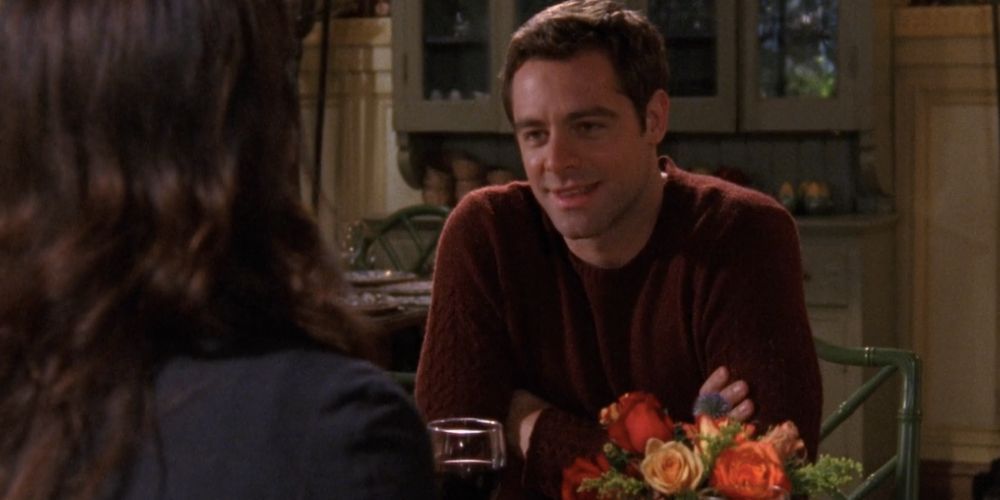 Christopher Hayden sitting with Lorelai on a date on Gilmore Girls