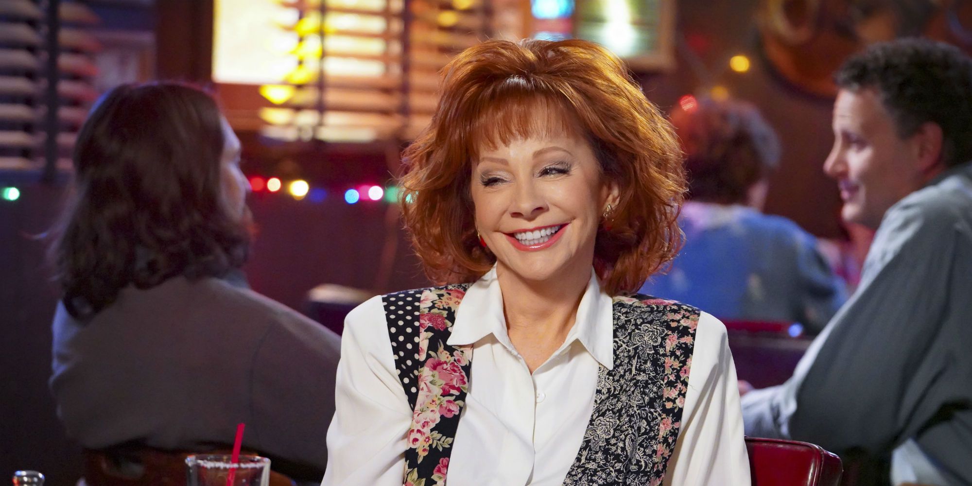 Reba McEntire smiling in a bar in Young Sheldon