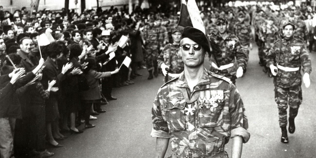 Outdoor military scene in a huge parade crowd from Battle of Algiers.