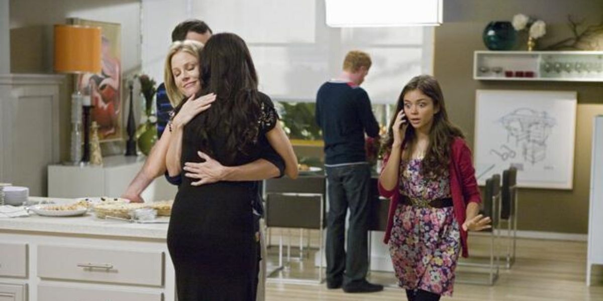 Claire and Gloria hugging in Modern Family