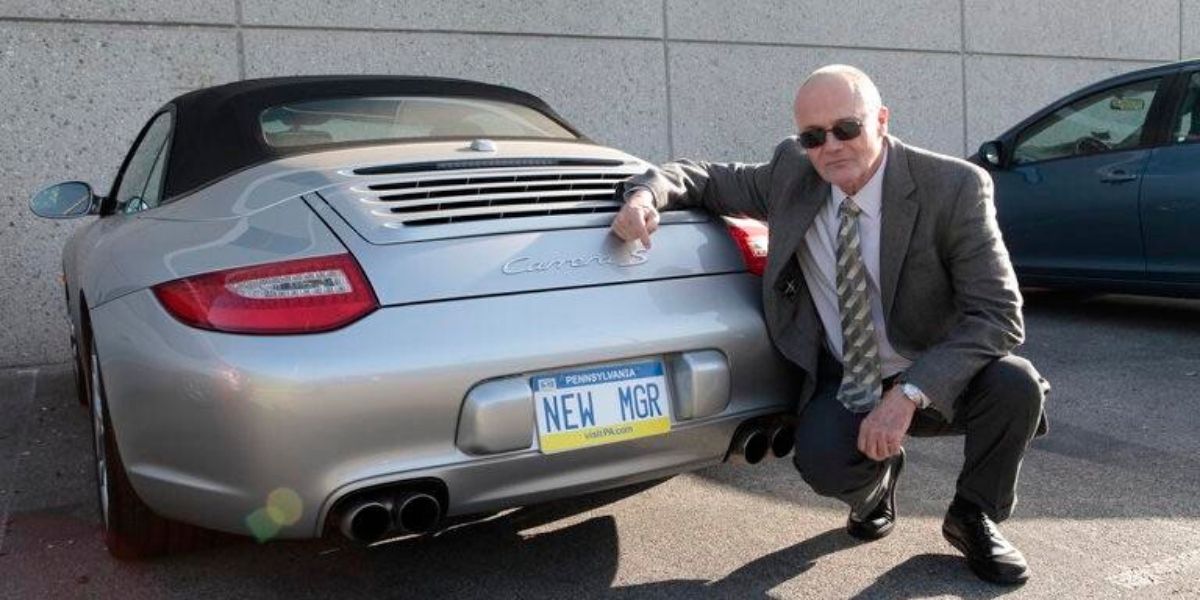 Creed poses next to his Porsche in The Office