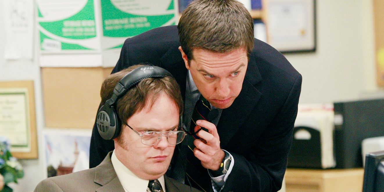 Andy lifts Dwight's headphones.