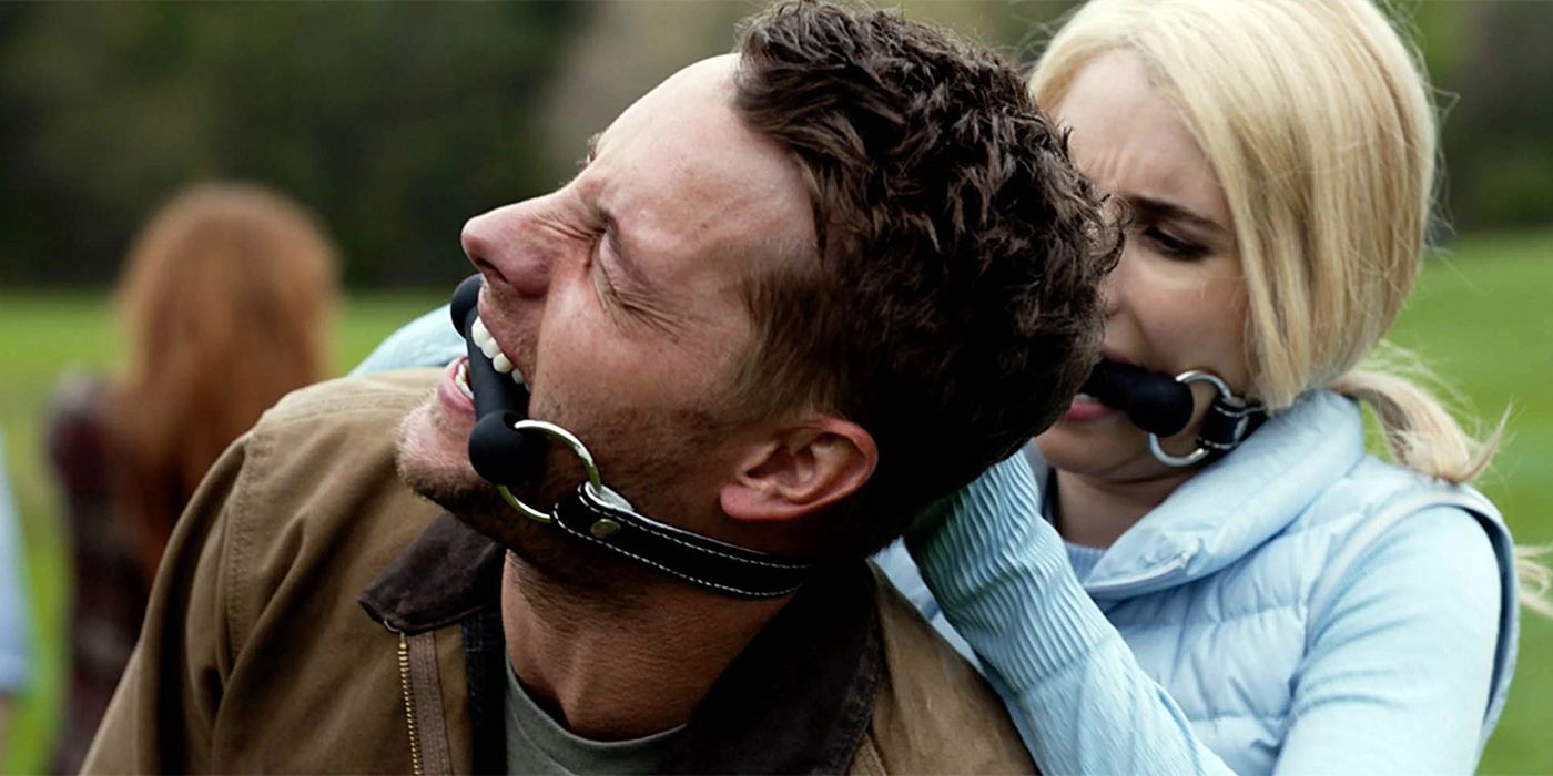 Yoga Pants (Emma Roberts) and Trucker (Justin Hartley) gagged in a field in The Hunt