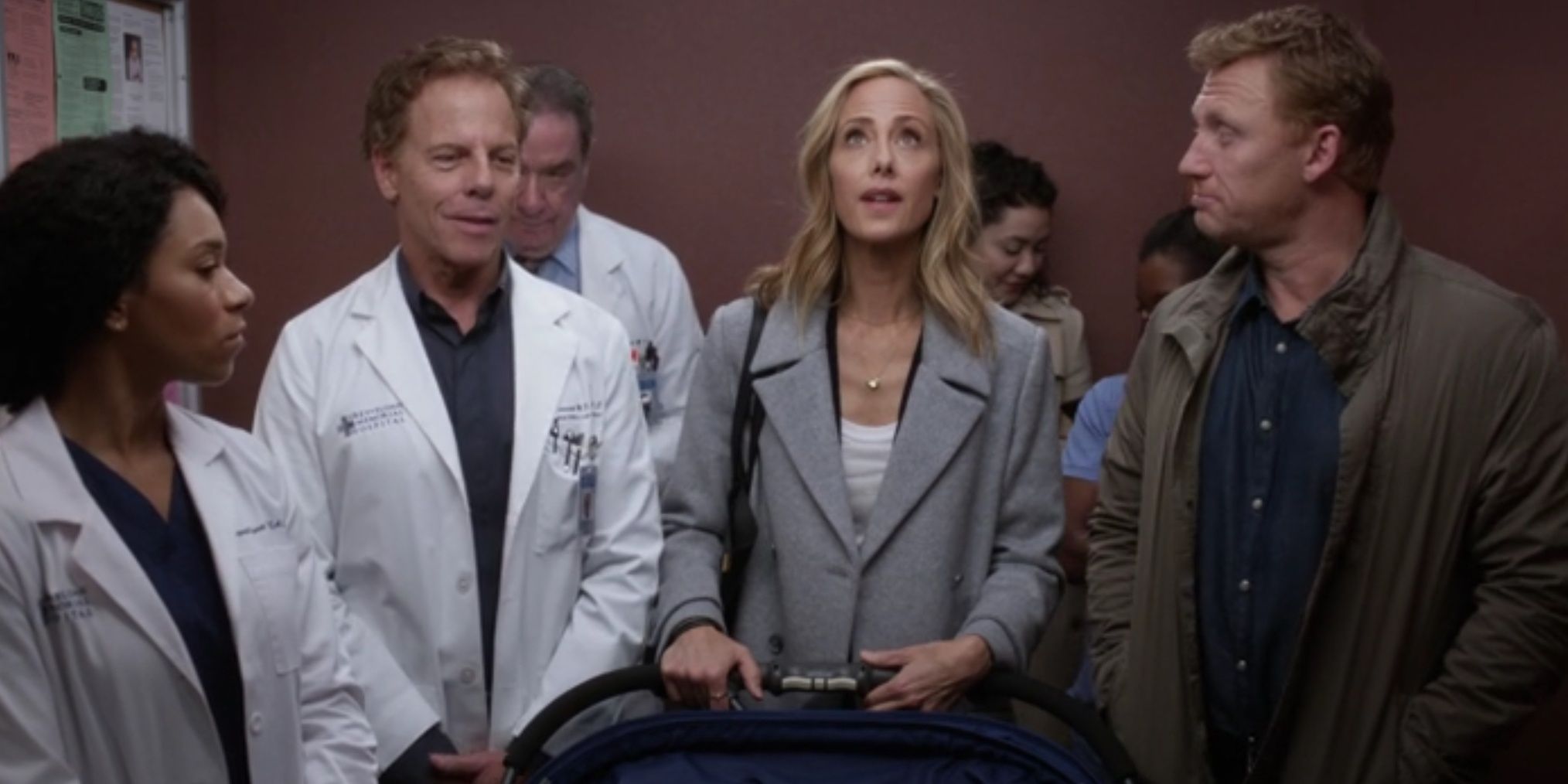 Teddy waits in the elevator with fellow doctors in Grey's Anatomy