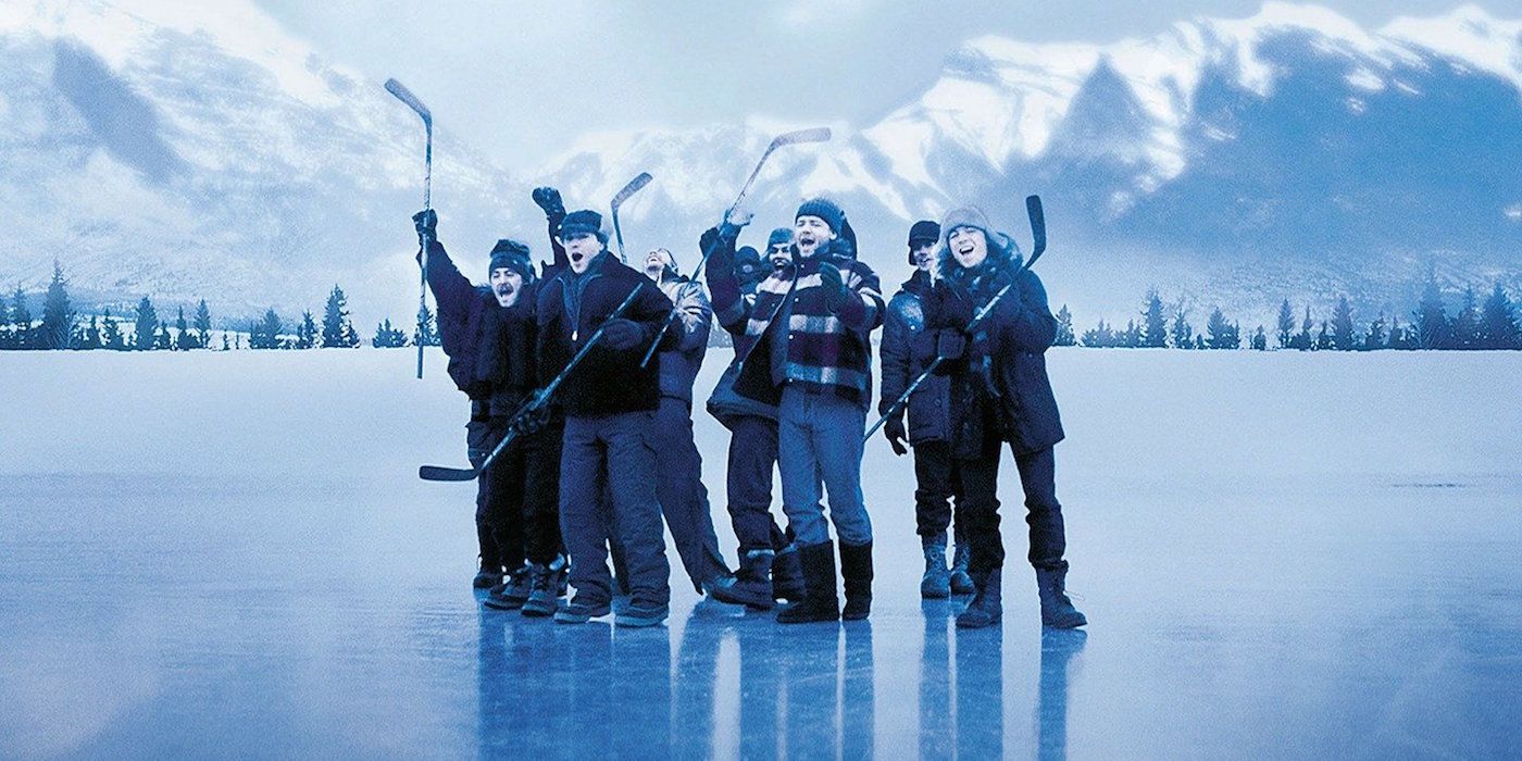 The team cheers while standing on a frozen lake in Mystery, Alaska