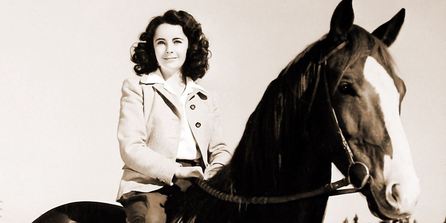 Elizabeth Taylor sitting atop a horse in National Velvet