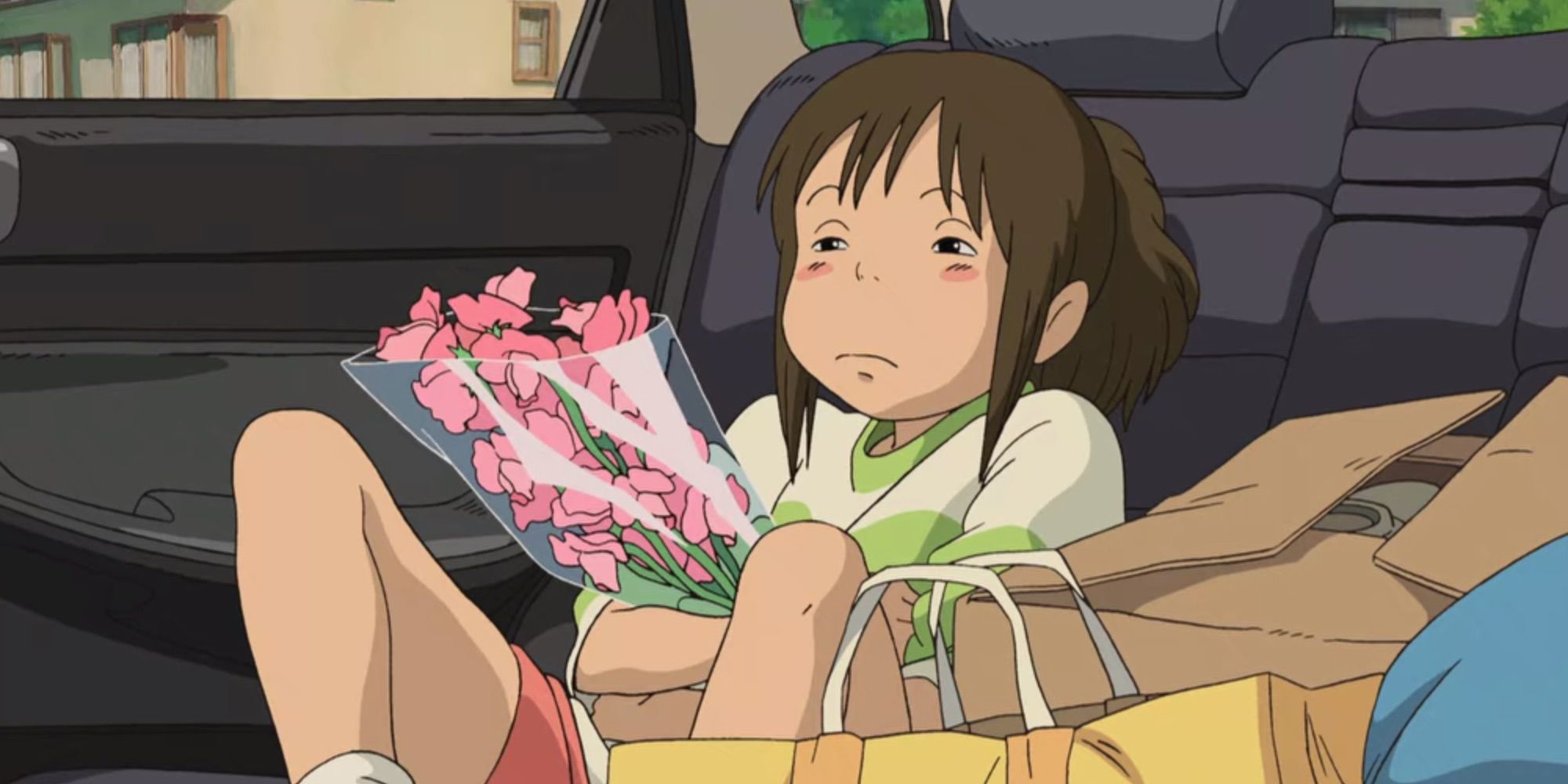Chihiro in the backseat of the car, arms crossed, in Spirited Away
