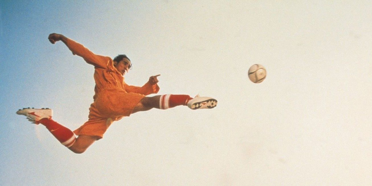 A man flying through the air about to kick a soccer ball in Shaolin Soccer