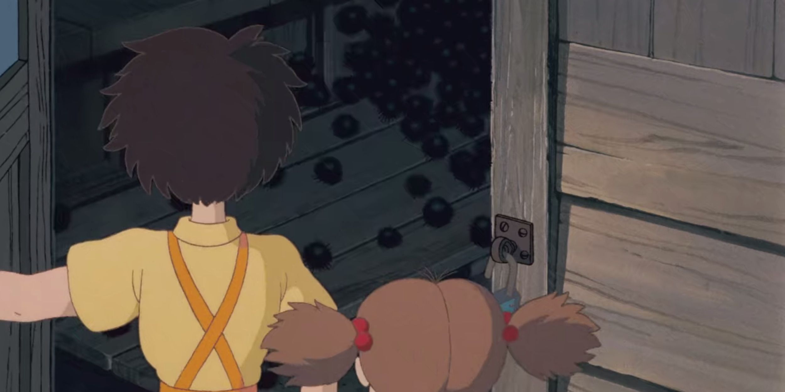 Mei and Satsuki open a door into darkness in their house in My Neighbor Totoro