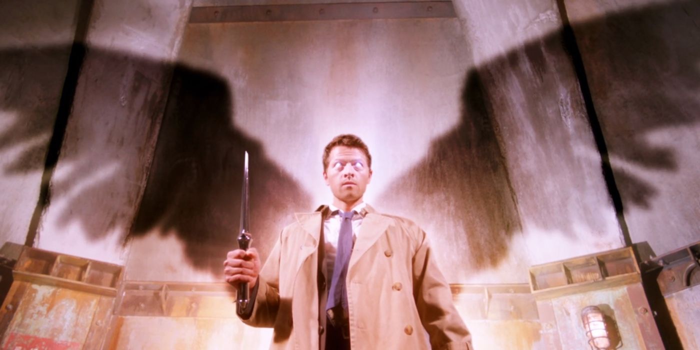 Castiel holds a knife as his wings appear in shadow in Supernatural
