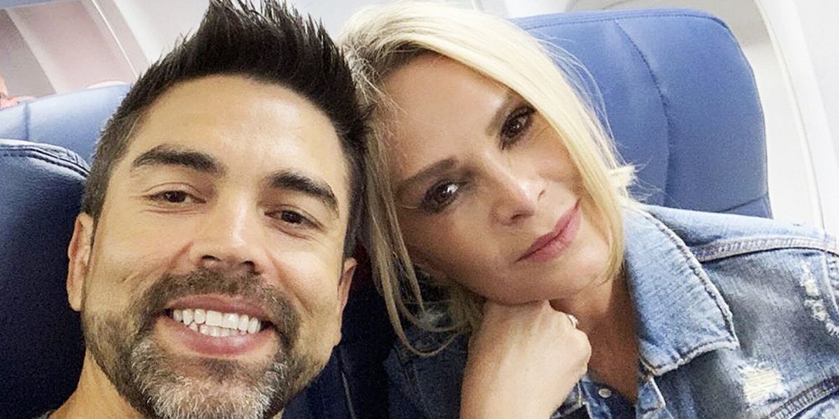 Eddie and Tamra smiling on a plane on The Real Housewives Of Orange County