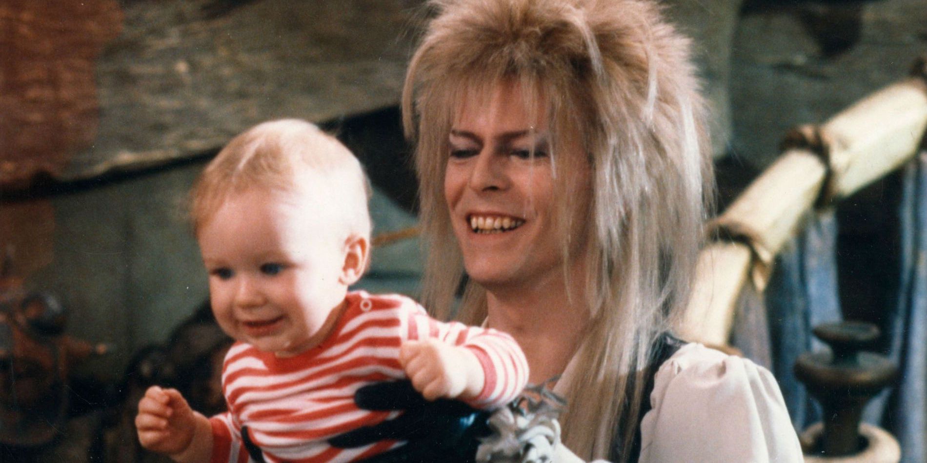 Jareth holding Toby in Labyrinth.