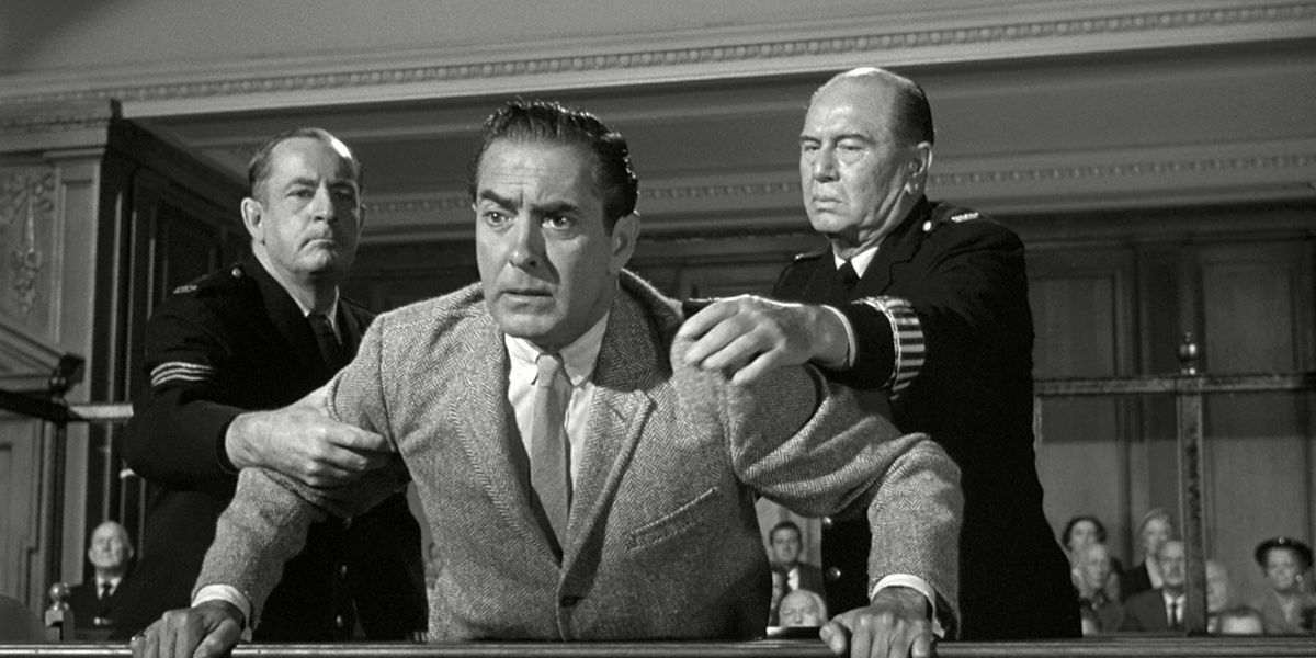 A man being held back by two bailiffs in a heated moment in Witness for the Prosecution