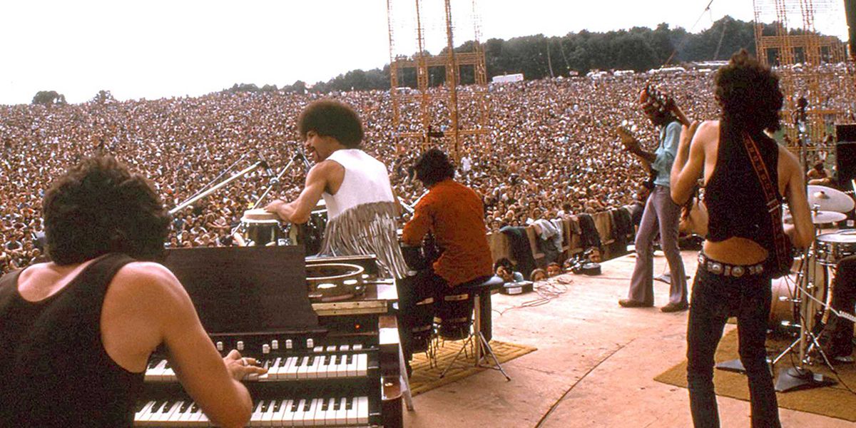 A group performing on stage at Woodstock.