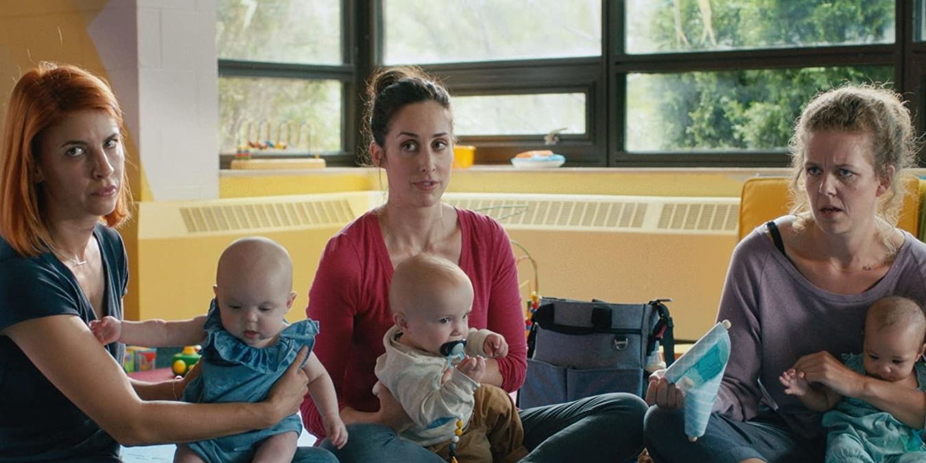 Anne, Kate and Frankie holding their babies in a class in Workin' Moms