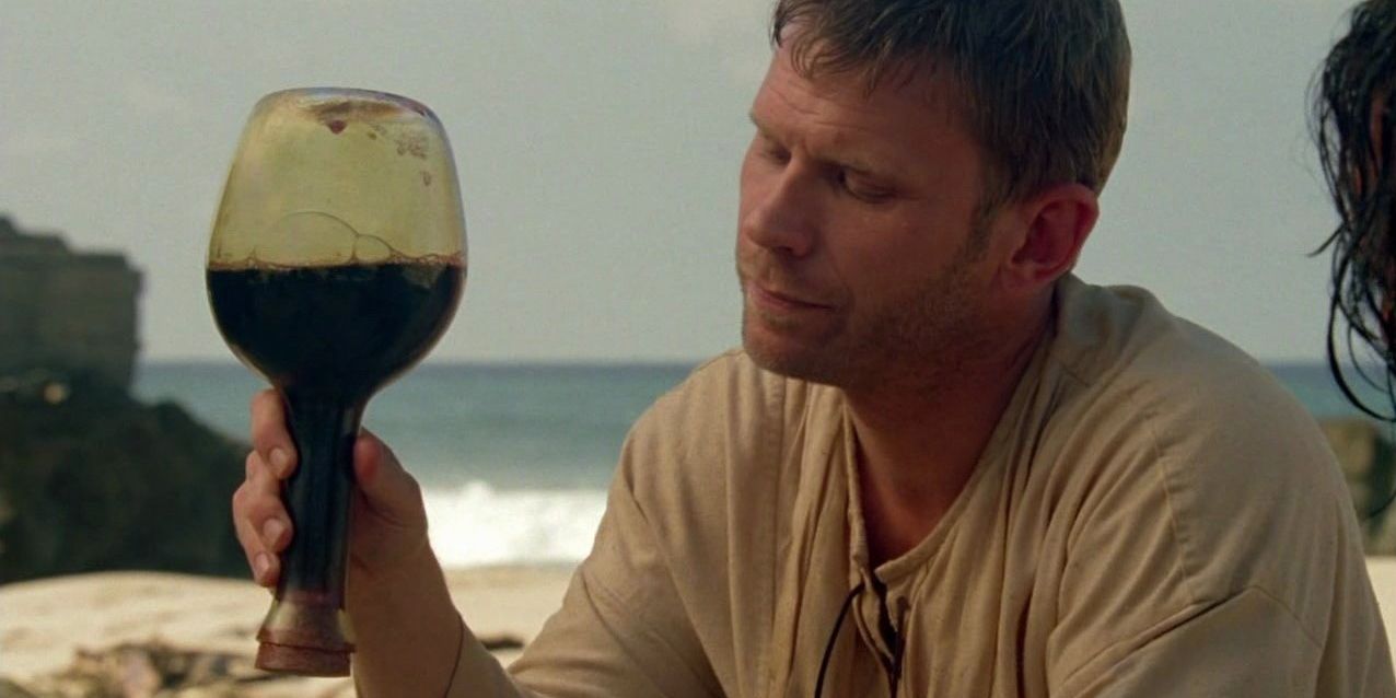 Jacob holding up a glass on the island in Lost