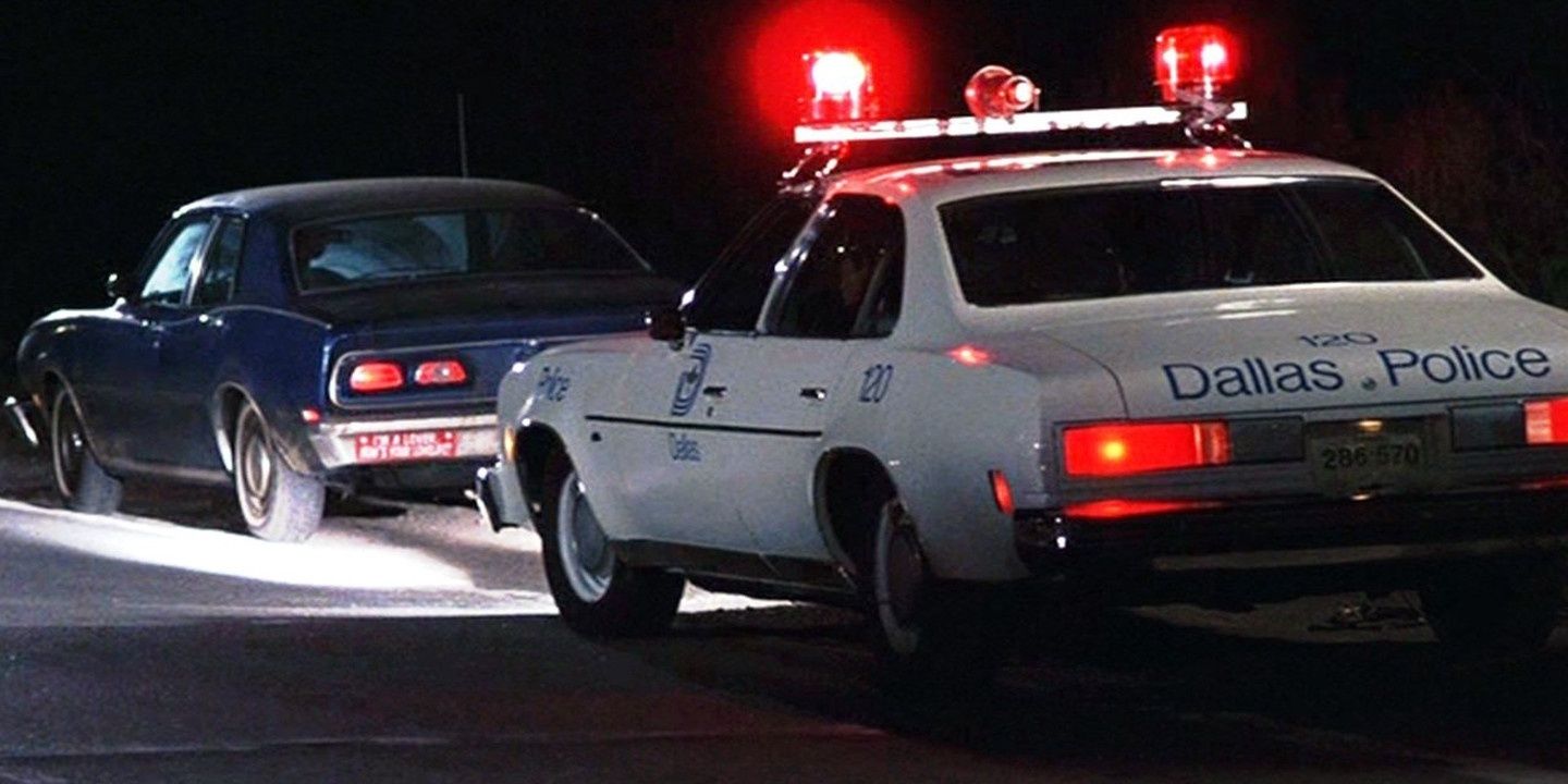 A cop car pulls over a motorist from a reenactment in the Thin Blue Line