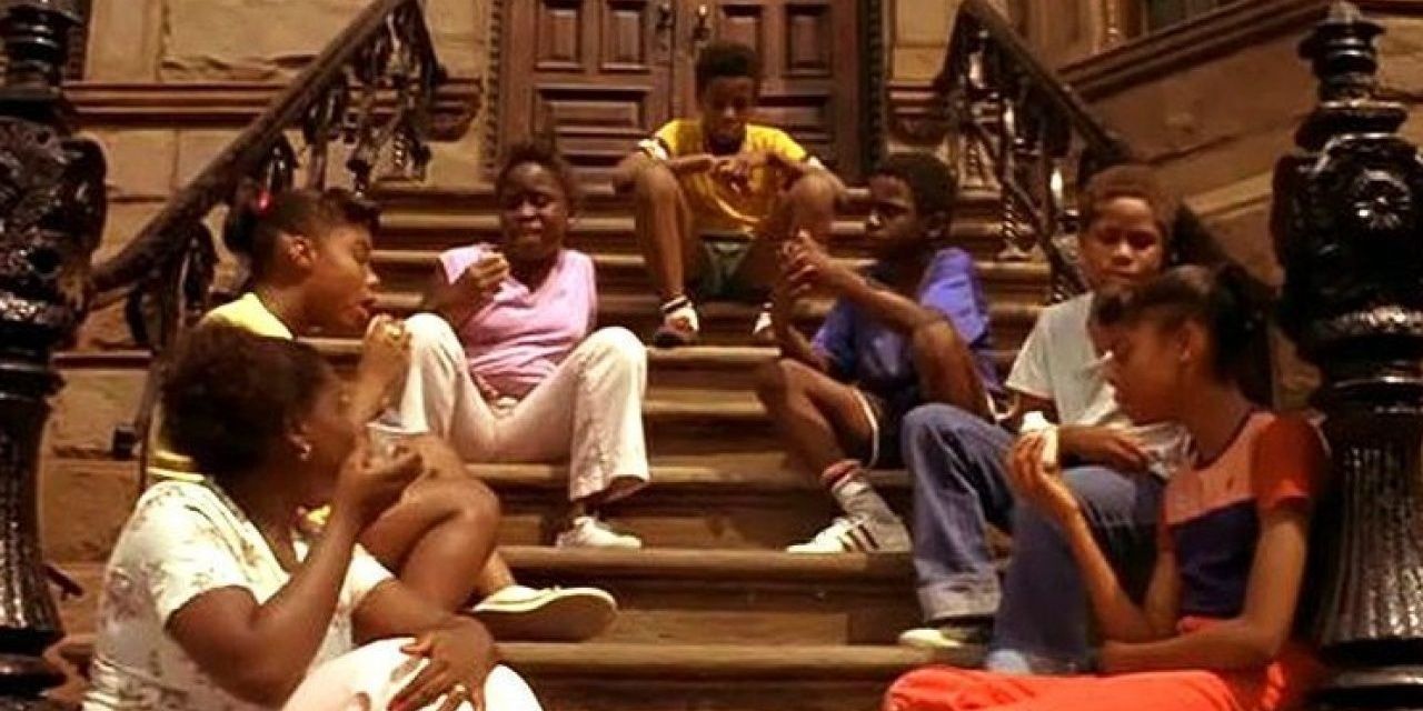A group of children sitting on a staircase in Crooklyn.