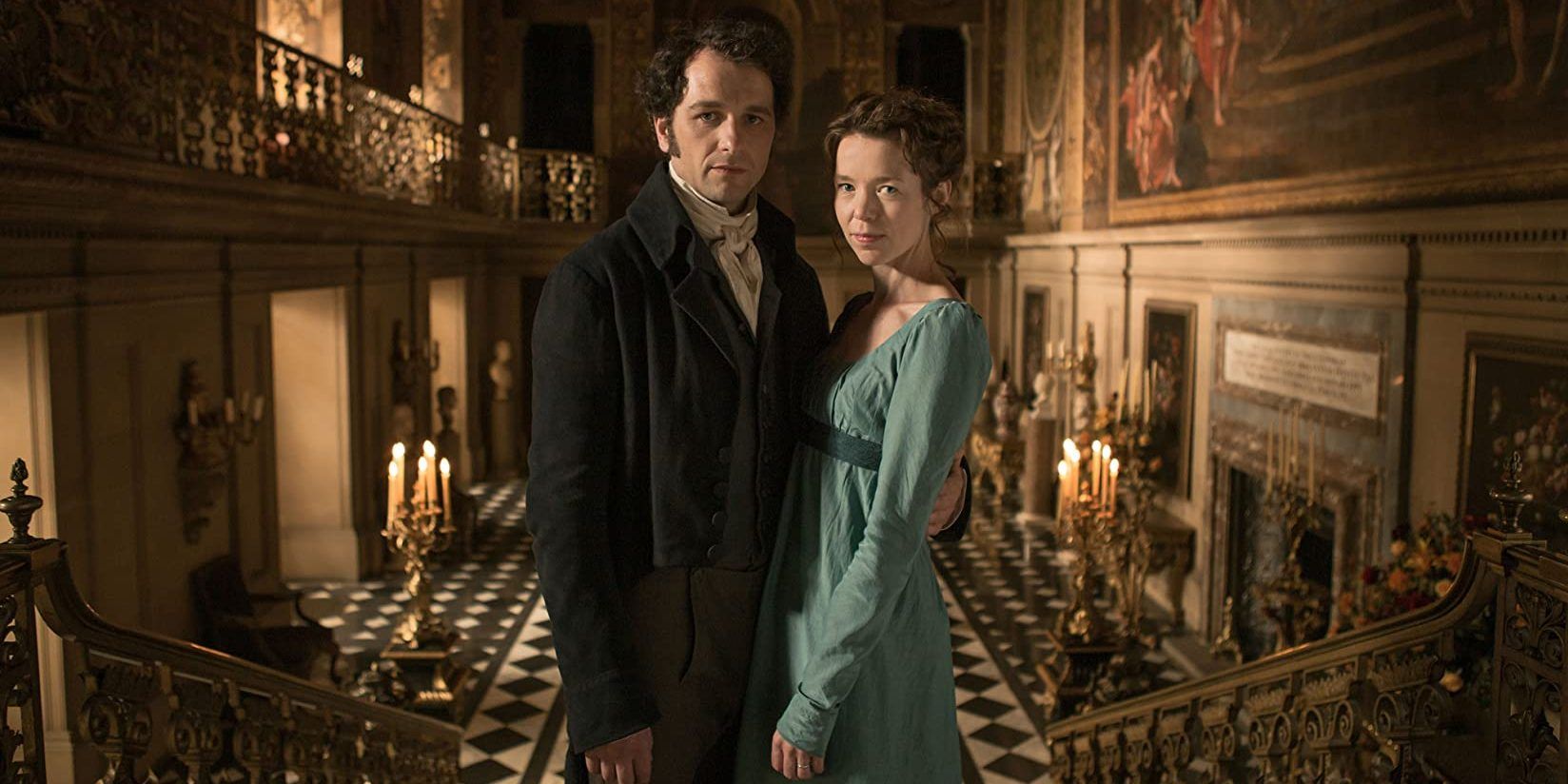 Darcy and Elizabeth stand with their arms around each other and face the audience on the stairs in Death Comes To Pemberley