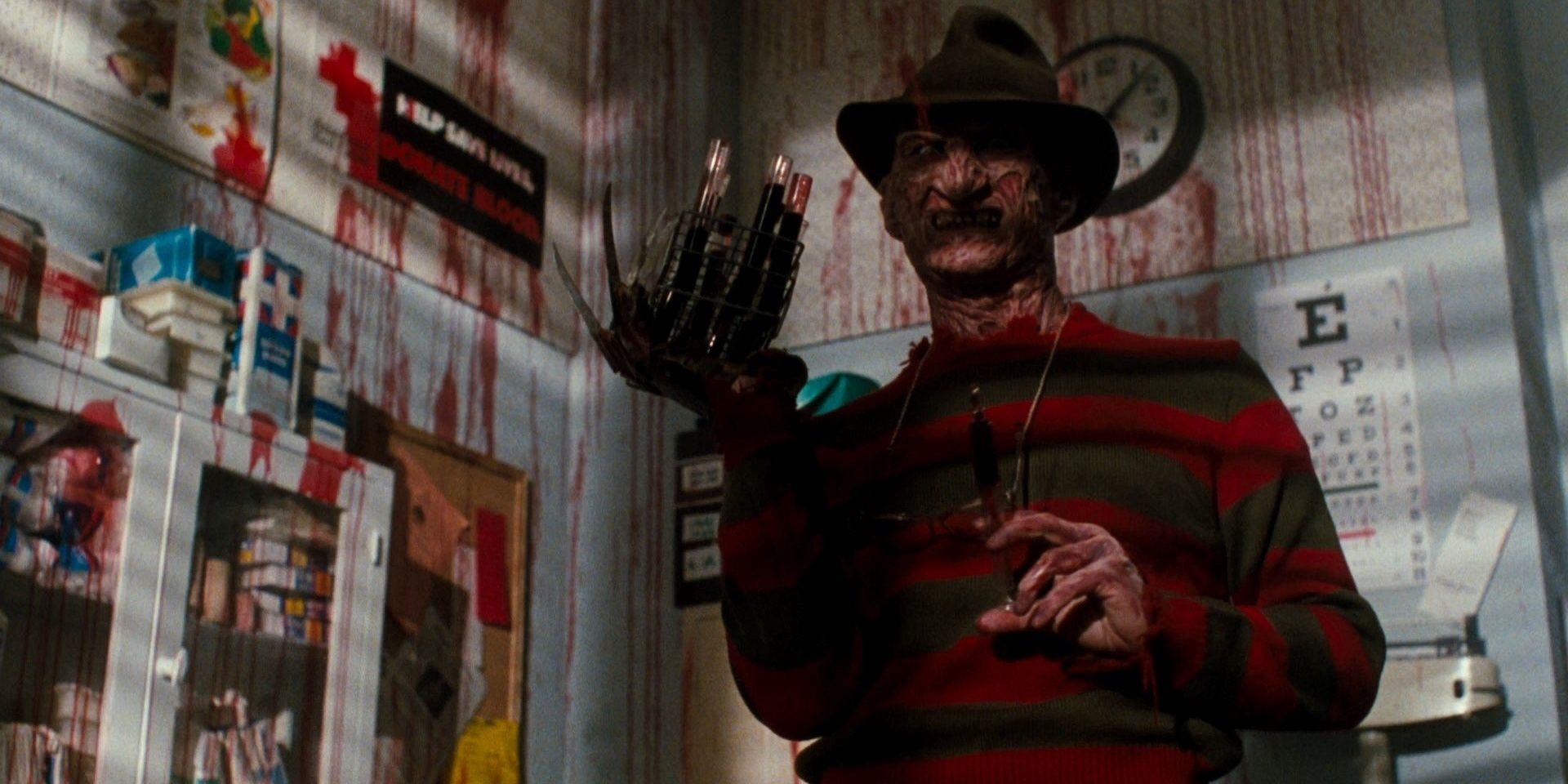 Freddy Krueger (Robert Englund) grinning sinisterly, with vials of blood attached to the blades of his glove in A Nightmare on Elm Street (1984)