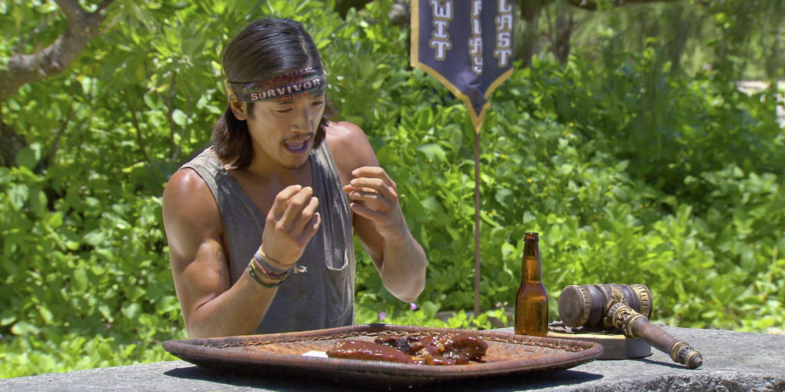 A Survivor contestant eats some meat