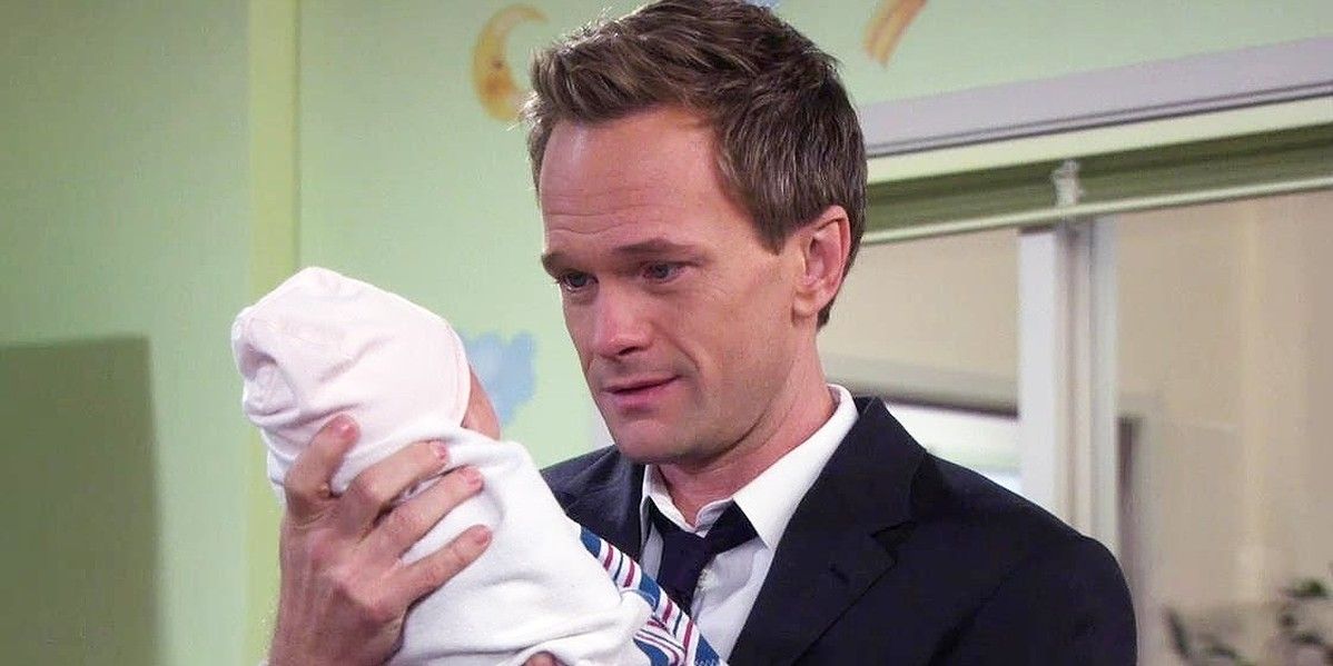 Barney holding his baby in How I Met Your Mother