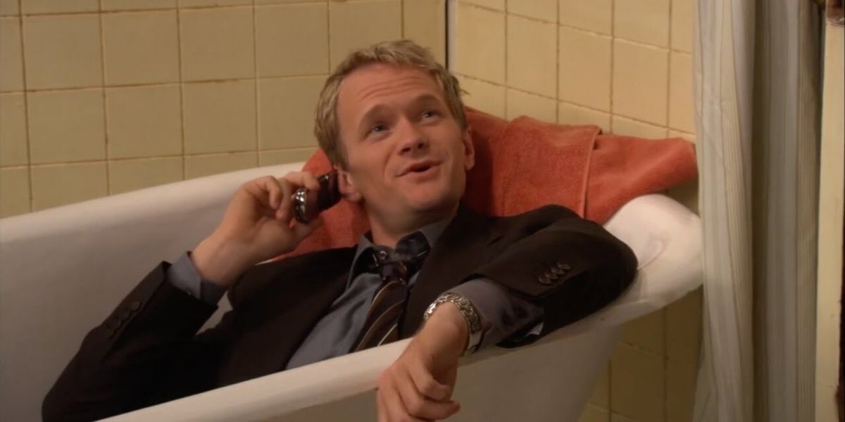Barney Stinson sitting in a bathtub on the phone in How I Met Your Mother.