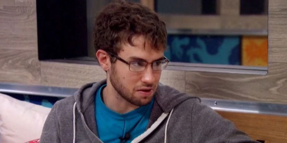 Steve Moses from Big Brother sitting in the house, looking at someone out of frame to his right.