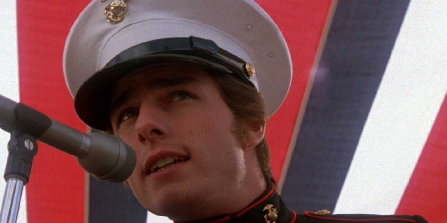 Tom Cruise in his military uniform talking into a microphone in Born On The Fourth Of July