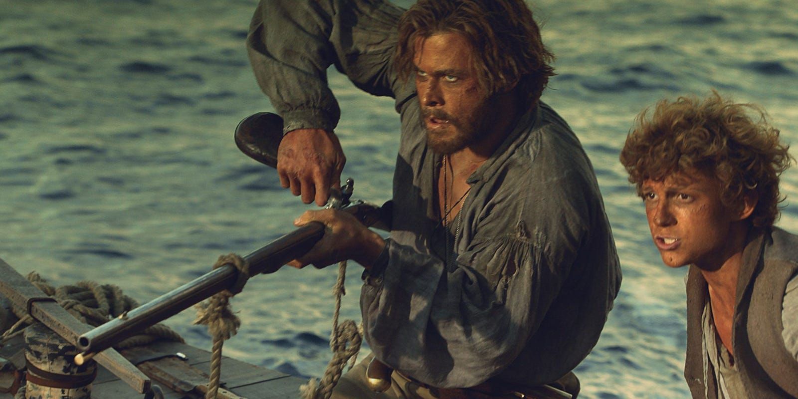 Chris Hemsworth and Tom Holland on a boat in In the Heart of the Sea