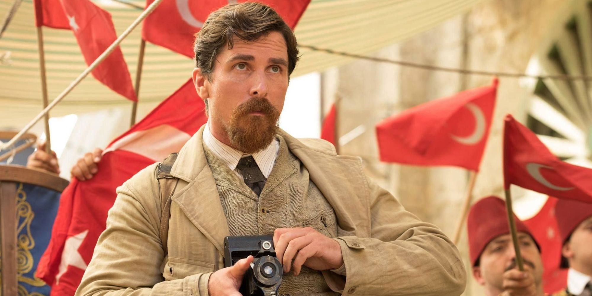 Christian Bale with a camera in The Promise
