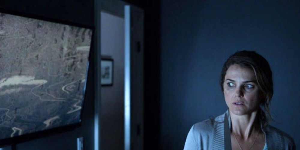 Keri Russell looking scared in her house in Dark Skies