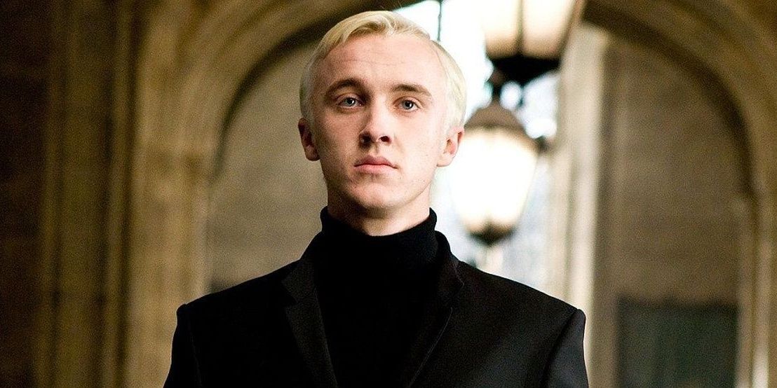 Draco Malfoy walking through Hogwarts.