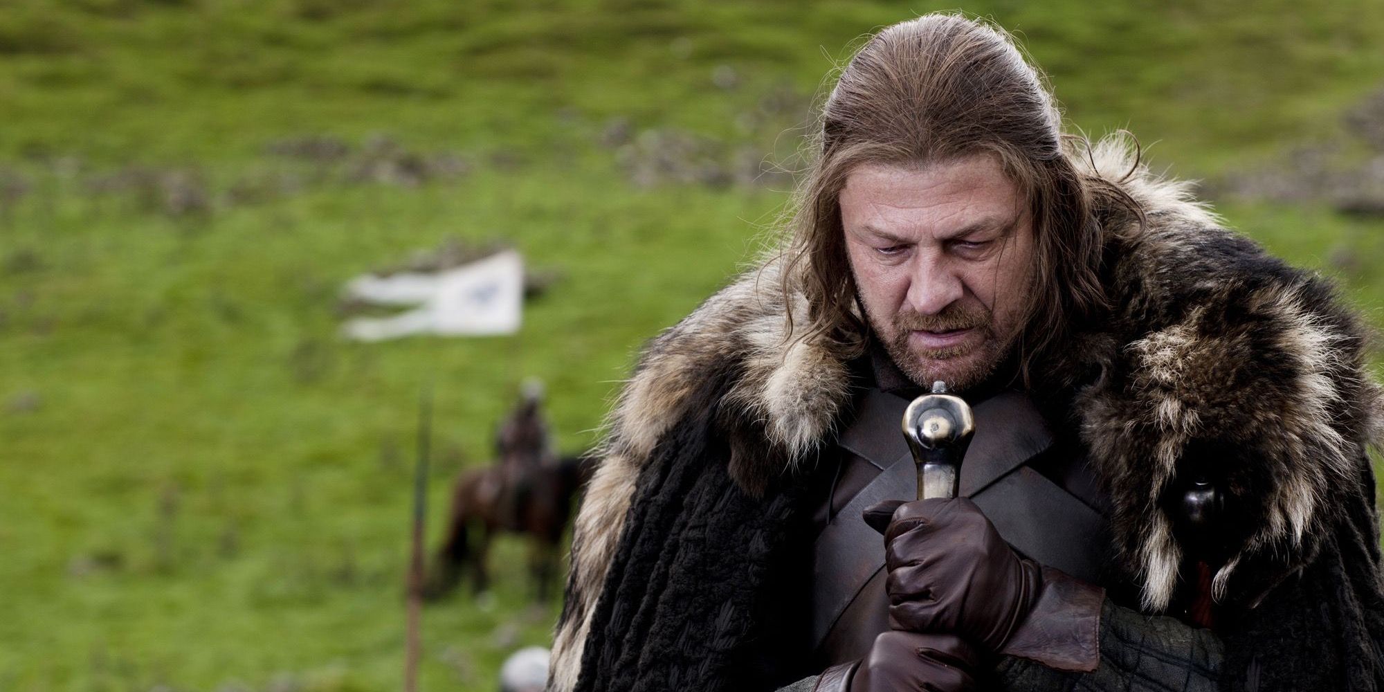 Ned Stark leans on his sword