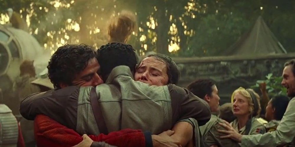Finn Rey Poe hugging during the final celebrations on Ajan Kloss in the Rise Of Skywalker