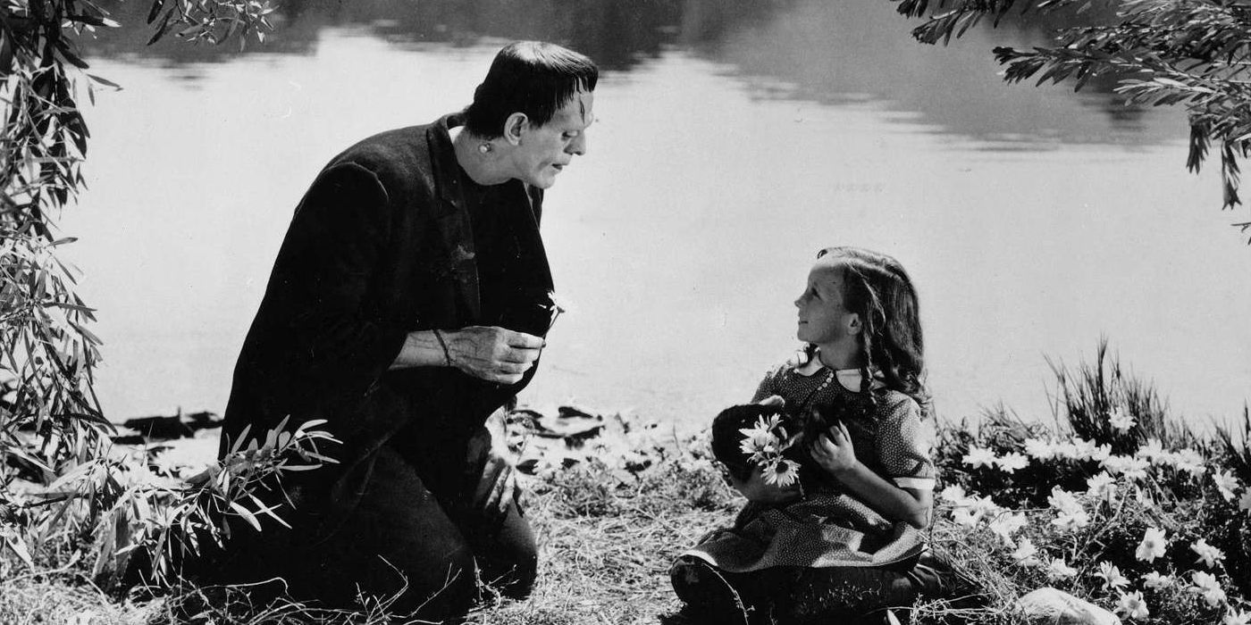 Frankenstein's monster kneels next to a little girl by the water in Frankenstein.