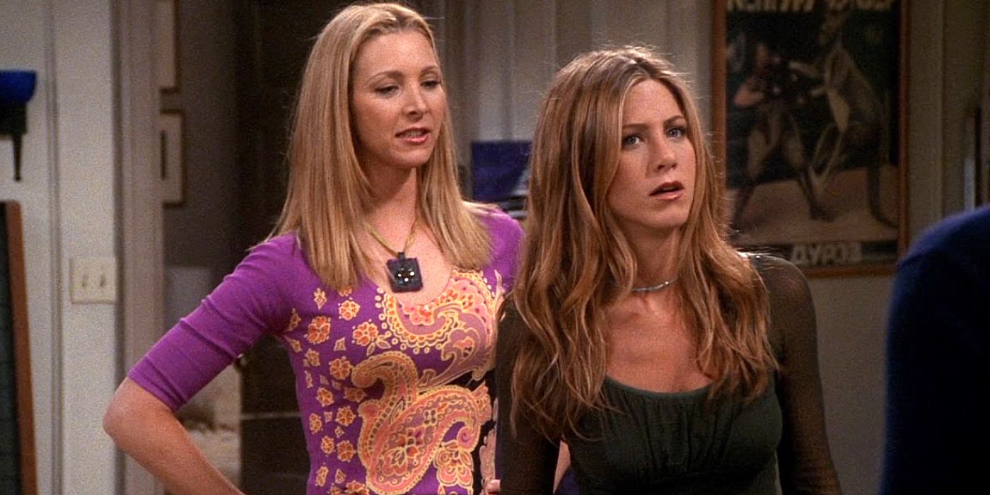 Phoebe in a purple printed top standing with her hands on her waist and Rachel wearing a black top