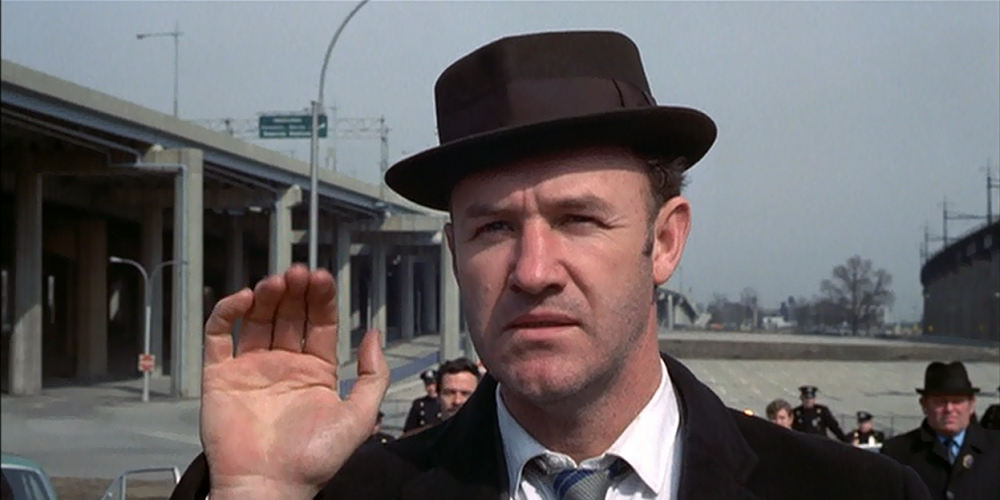 Gene Hackman waves in The French Connection