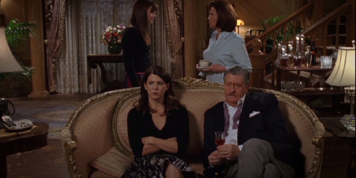 Lorelai and Richard sitting on the couch near Rory and Emily on Gilmore Girls