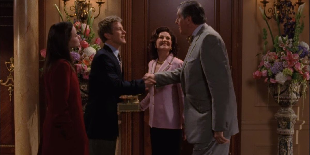 Rory, Logan, Emily, and Richard in the senior Gilmores' front hall. Logan shakes Richard's hand.