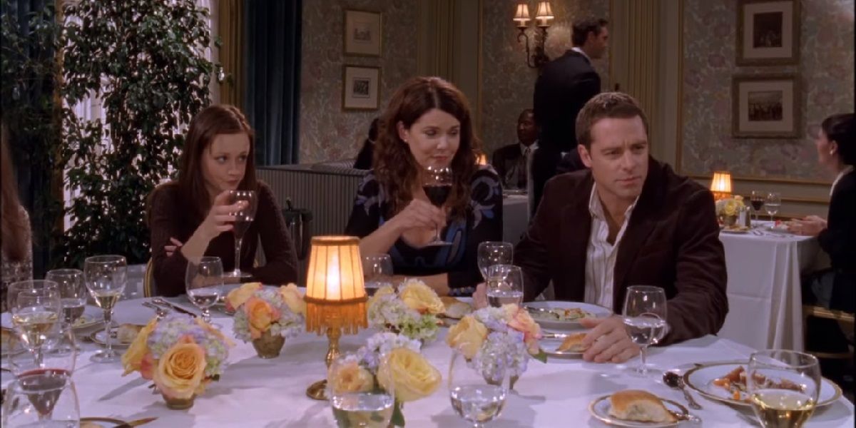 Rory, Lorelai, and Christopher sitting at a table on Gilmore Girls