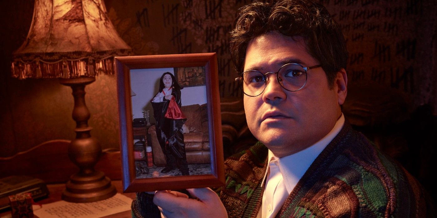 Guillermo holding a photo of himself as a child dressed as a vampire in What We Do in the Shadows